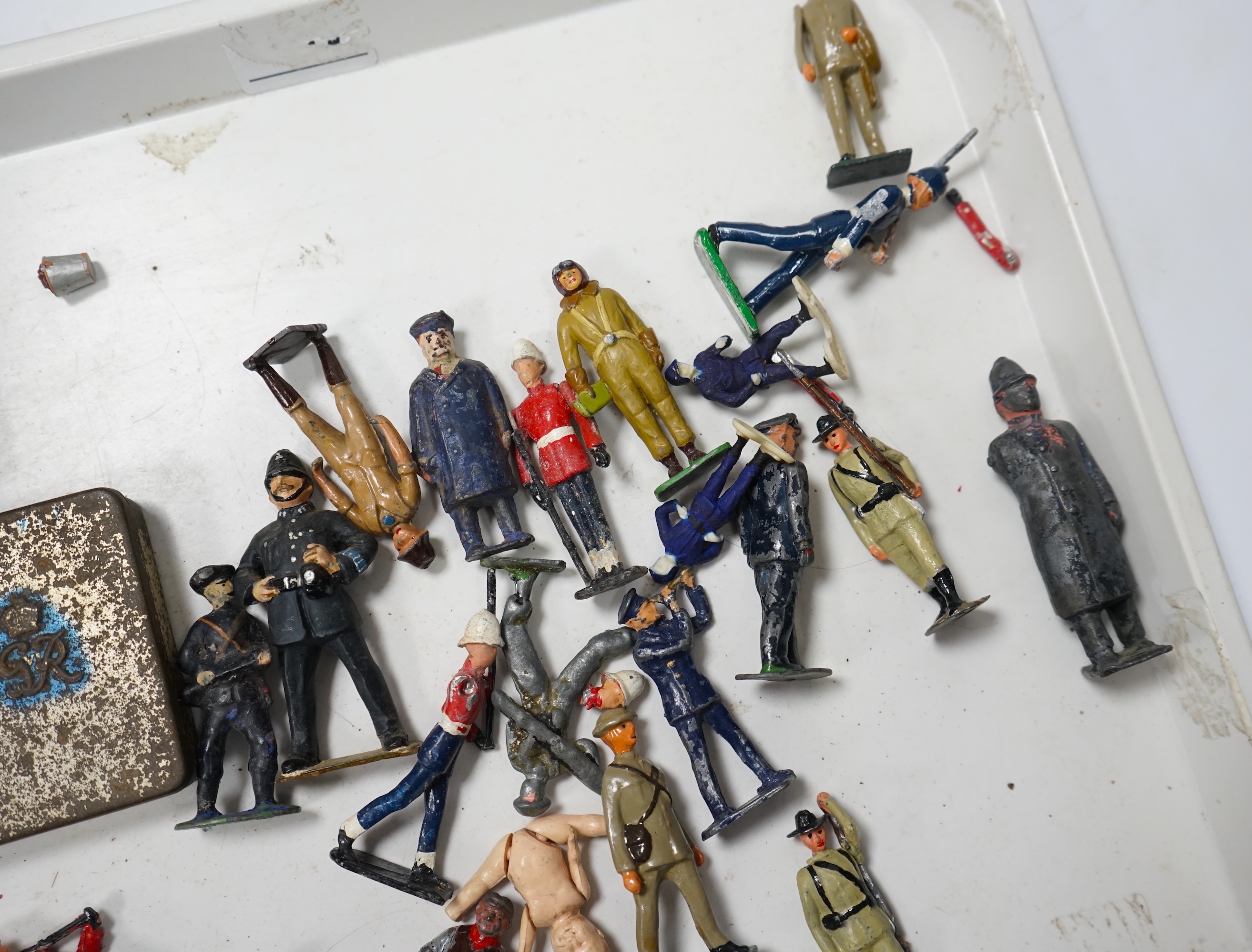 A collection of Britains lead soldiers, mostly British infantry in khaki, including some with gas masks, together with railway station figures by Johillco, etc., plus two Coronation tins, etc. Condition - poor to fair.